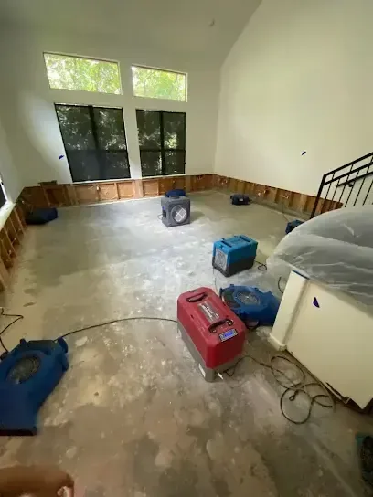 A room with the lower walls flood cut and drying equipment set across the floor