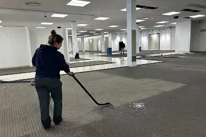 Extraction wand passing over wet commercial carpet