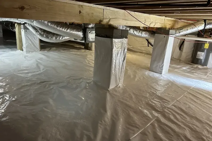 Pump hose removing standing water from a crawl space