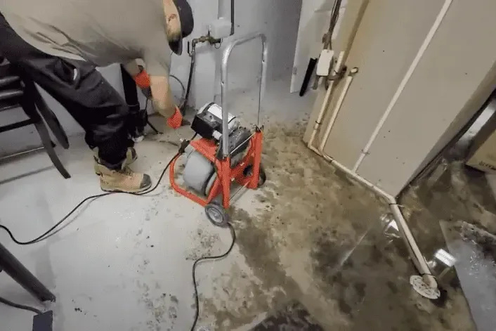 Drain machine working on a backed-up floor drain